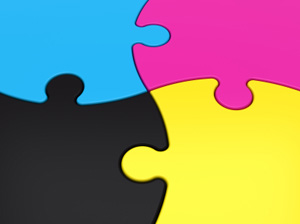A four piece puzzle, put together, in cyan, magenta, yellow and black.